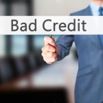 Business Man Holding Bad Credit Signage for Essential Credit in Credit Repair Software